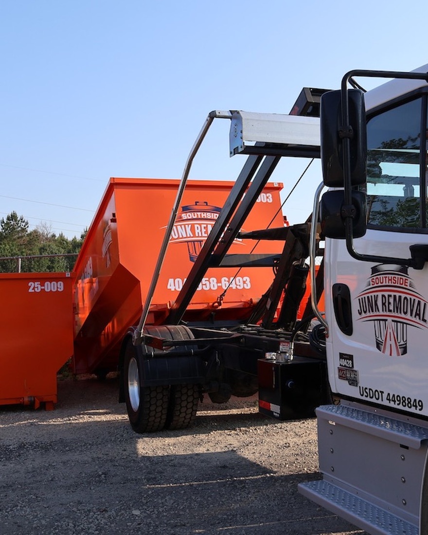 A Southside Junk Removal roll-off dumpster and branded hook-lift truck