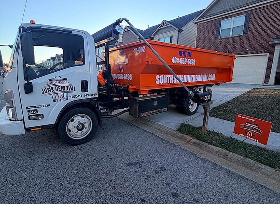 The Southside Junk Removal team in front of a branded truck at the Jonesboro headquarters